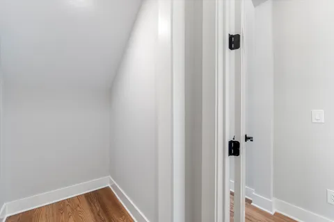 a small space with wooden floor and a window