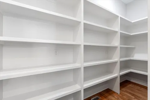 a view of walk in closet with empty racks