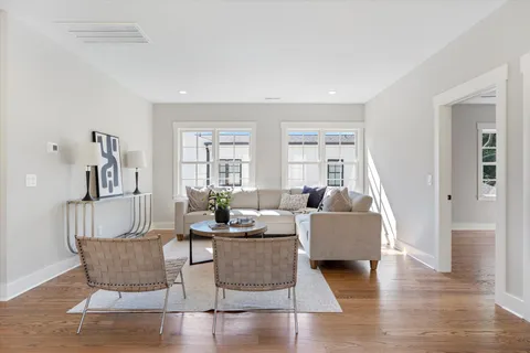 a living room with furniture and wooden floor