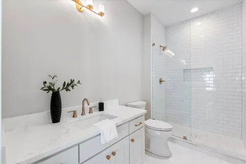 an empty room with window and ceiling fan