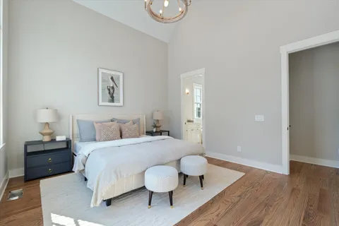 a bedroom with a bed and wooden floor