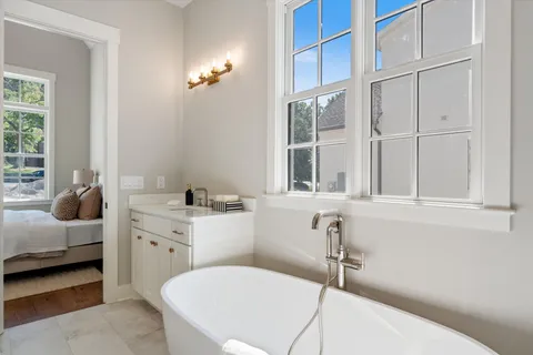 a bathroom with a sink and a chair