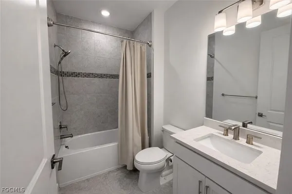 a bathroom with a granite countertop shower and a toilet
