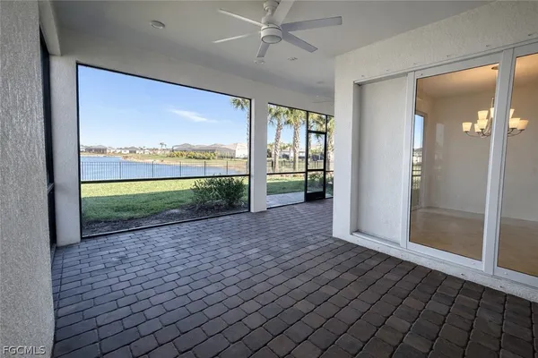 a view of a big room with wooden floor and a kitchen