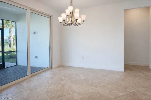 an empty room with sliding door and mountain view