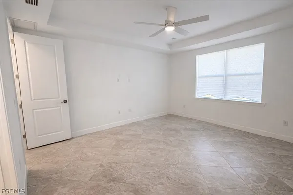 an empty room with closet and windows