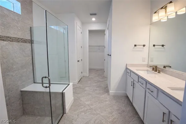 a bathroom with a granite countertop toilet and a sink