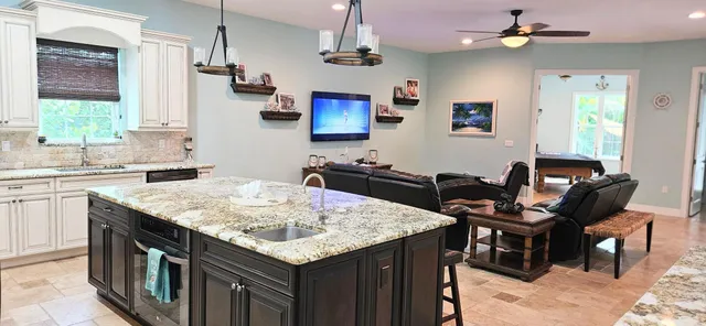 a view of a dining room with furniture and a large window