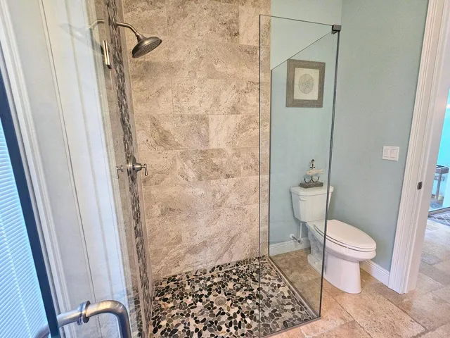 a living room with wooden floor and a dining table