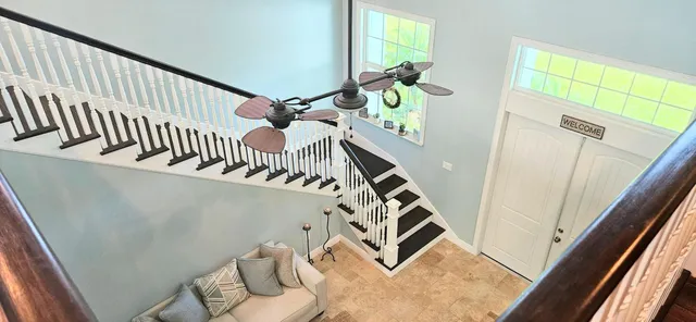 a view of a chairs and table in the balcony