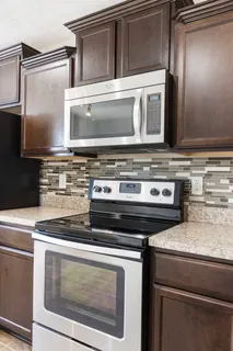 a stove top oven sitting inside of a kitchen