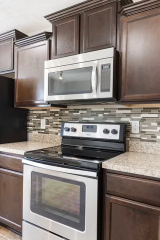 a stove top oven sitting inside of a kitchen
