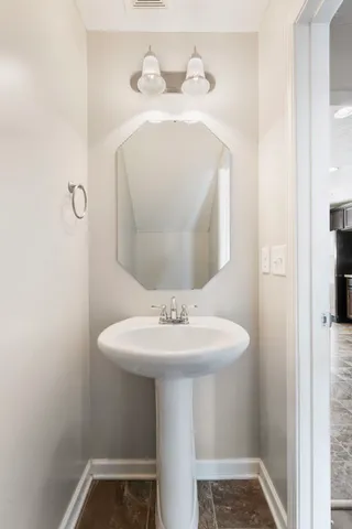 a bathroom with a sink and mirror