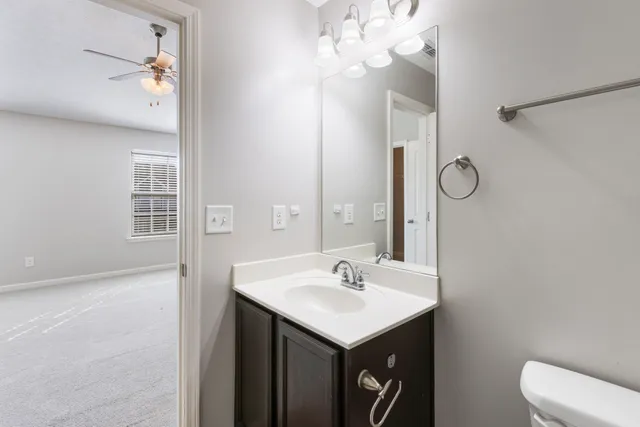 a bathroom with a sink a light fixture and a mirror