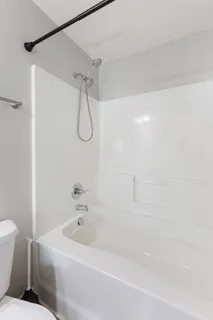 a bathroom with a bathtub and a shower