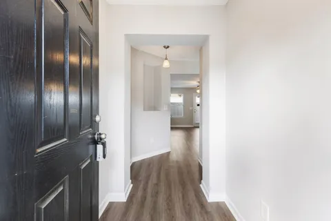a view of a hallway with wooden floor