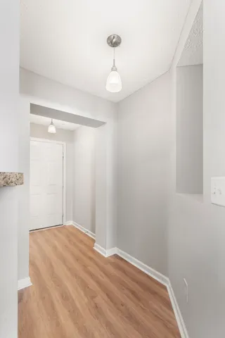 a view of a room with wooden floor and fan