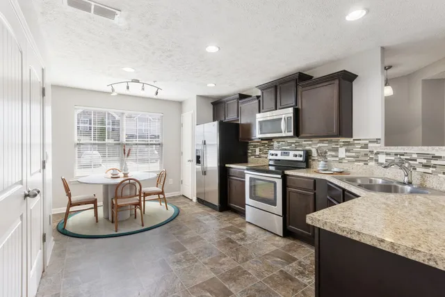 a kitchen with stainless steel appliances granite countertop a stove and a sink