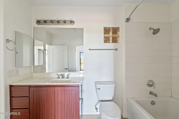 a bathroom with a granite countertop toilet a sink and bathtub