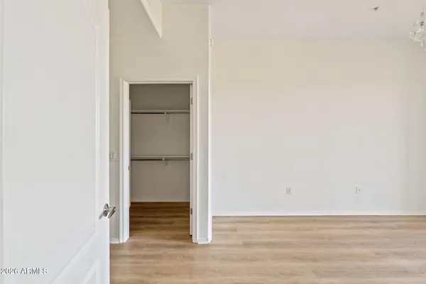 a view of walk in closet with wooden floor