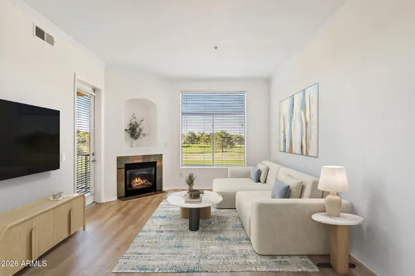 a living room with furniture a flat screen tv and a fireplace