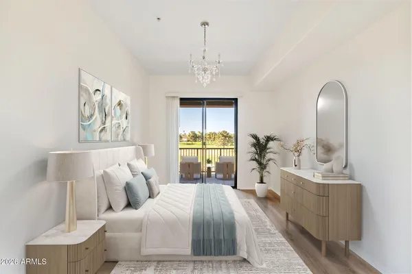 a bedroom with a bed and a chandelier