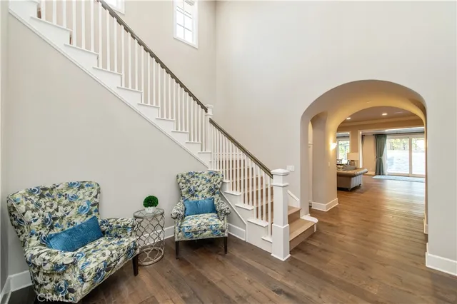 a view of entryway and hall with wooden floor