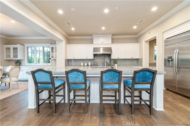 a large kitchen with stainless steel appliances granite countertop a granite counter tops and a stove