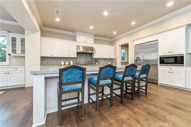a large kitchen with stainless steel appliances lots of counter top space