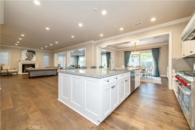 a view of a dining room with furniture a chandelier and wooden floor