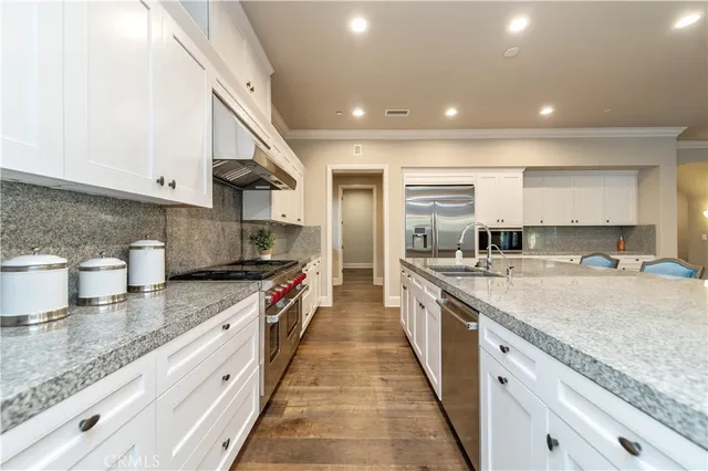 a view of a dining room with furniture a chandelier and wooden floor
