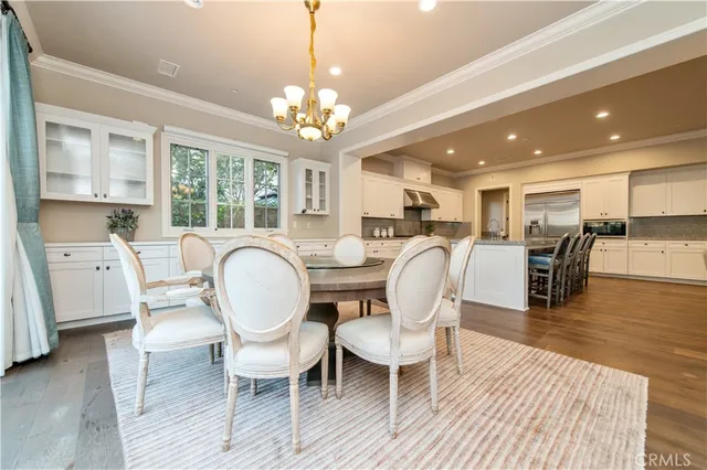 a dining room with furniture and large windows
