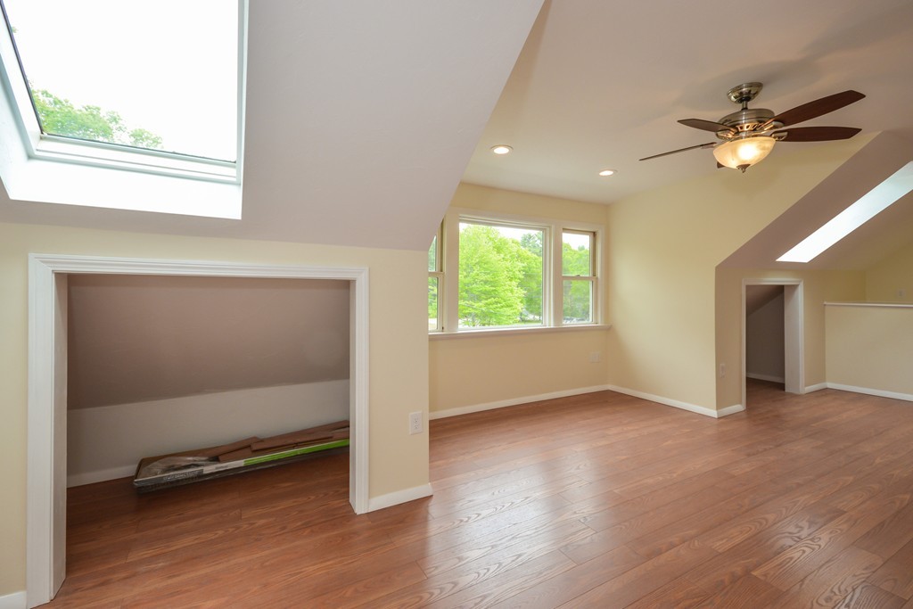8 Quaker Circle Pembroke, MA 02359 - Photo 19 of 30 an empty room with wooden floor and windows