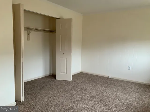an empty room with closet area