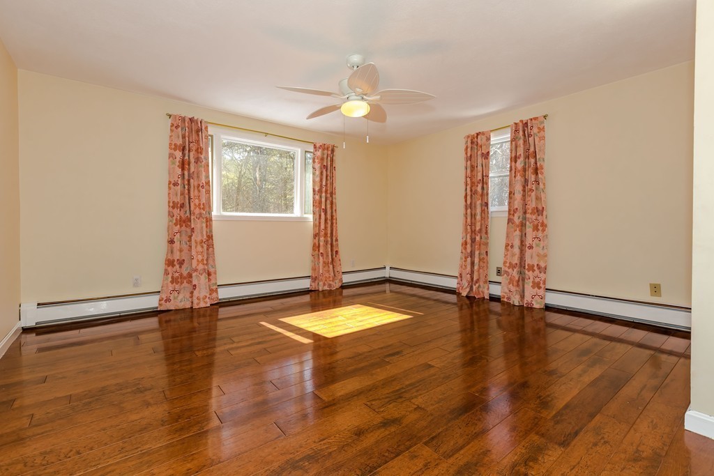 171 Taylor Road Stow, MA 01775 - Photo 14 of 18 an empty room with wooden floor and windows