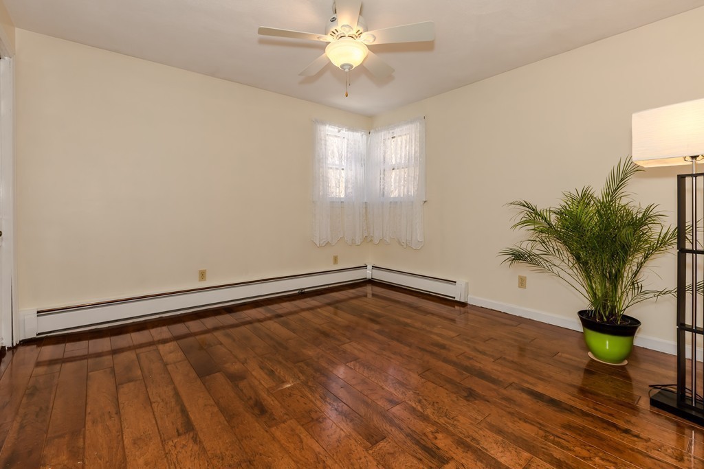 171 Taylor Road Stow, MA 01775 - Photo 16 of 18 a view of an empty room with window and wooden floor