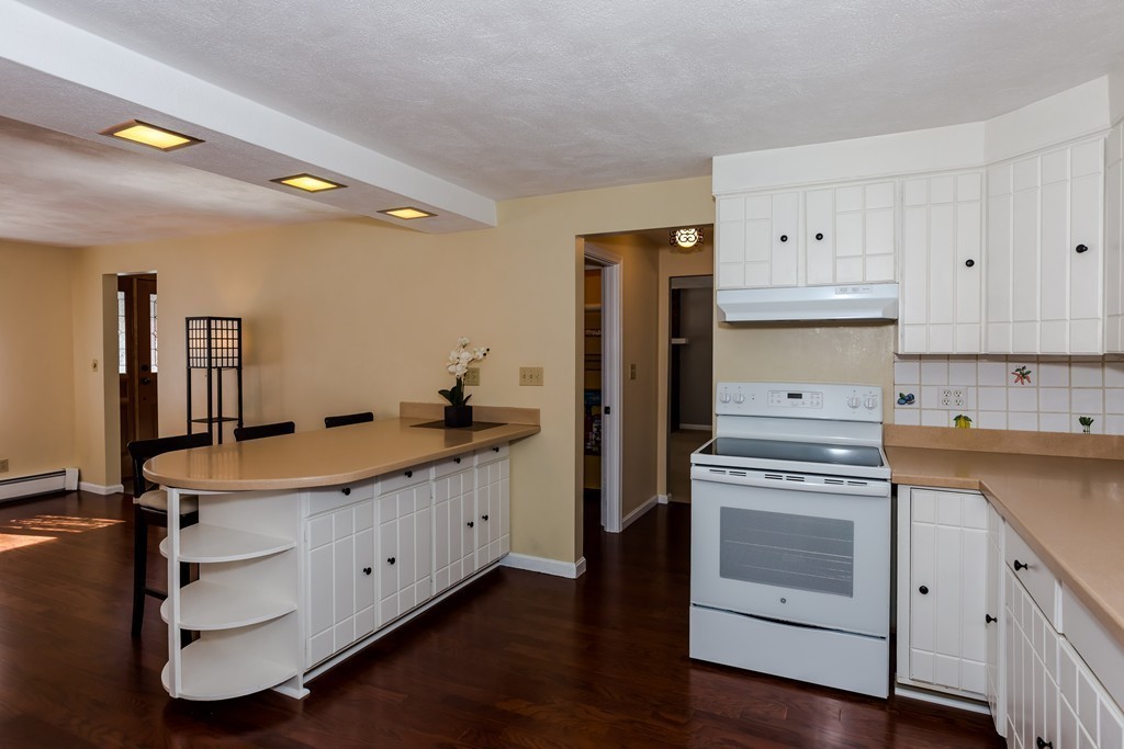 171 Taylor Road Stow, MA 01775 - Photo 3 of 18 a kitchen with a sink stove and cabinets