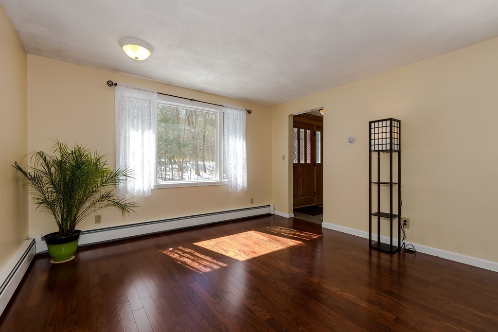 171 Taylor Road Stow, MA 01775 - Photo 5 of 18 a view of empty room with wooden floor and fan