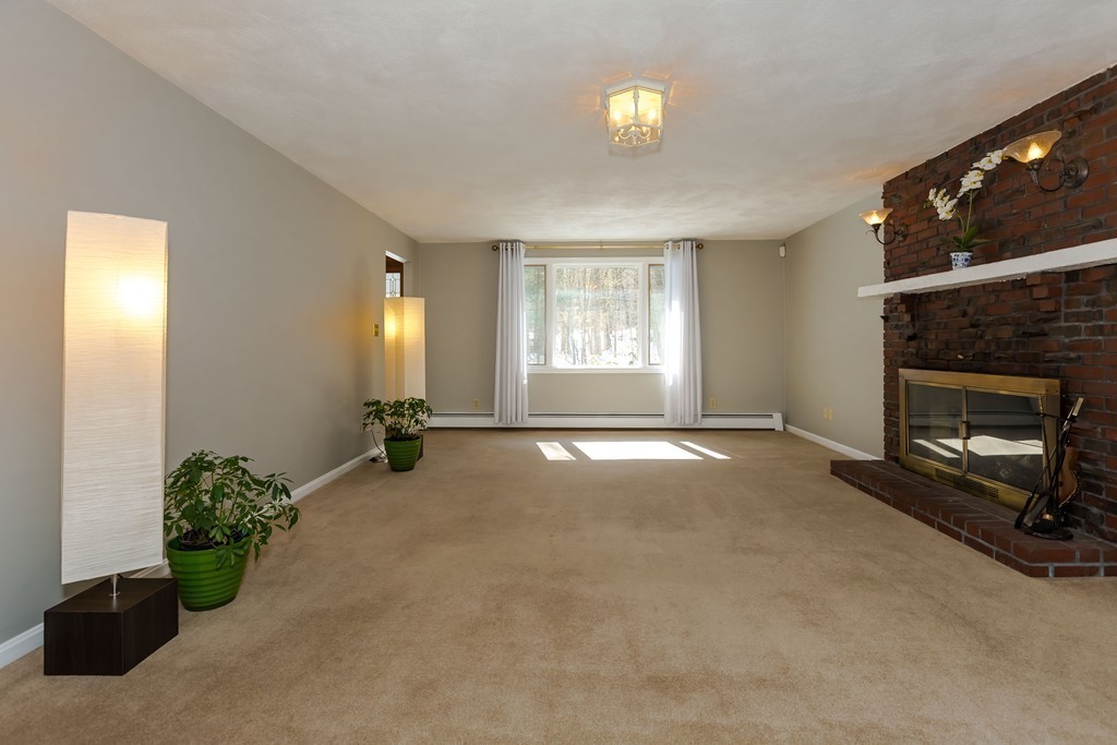 171 Taylor Road Stow, MA 01775 - Photo 7 of 18 a view of livingroom with furniture and a fireplace