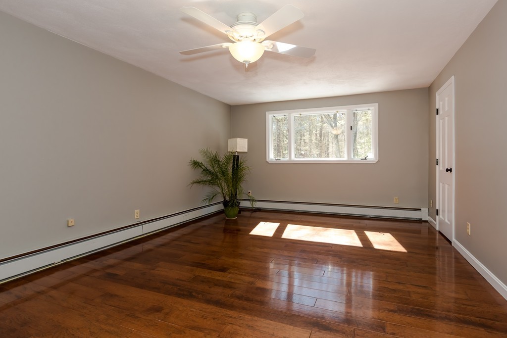 171 Taylor Road Stow, MA 01775 - Photo 10 of 18 a view of empty room with wooden floor and fan