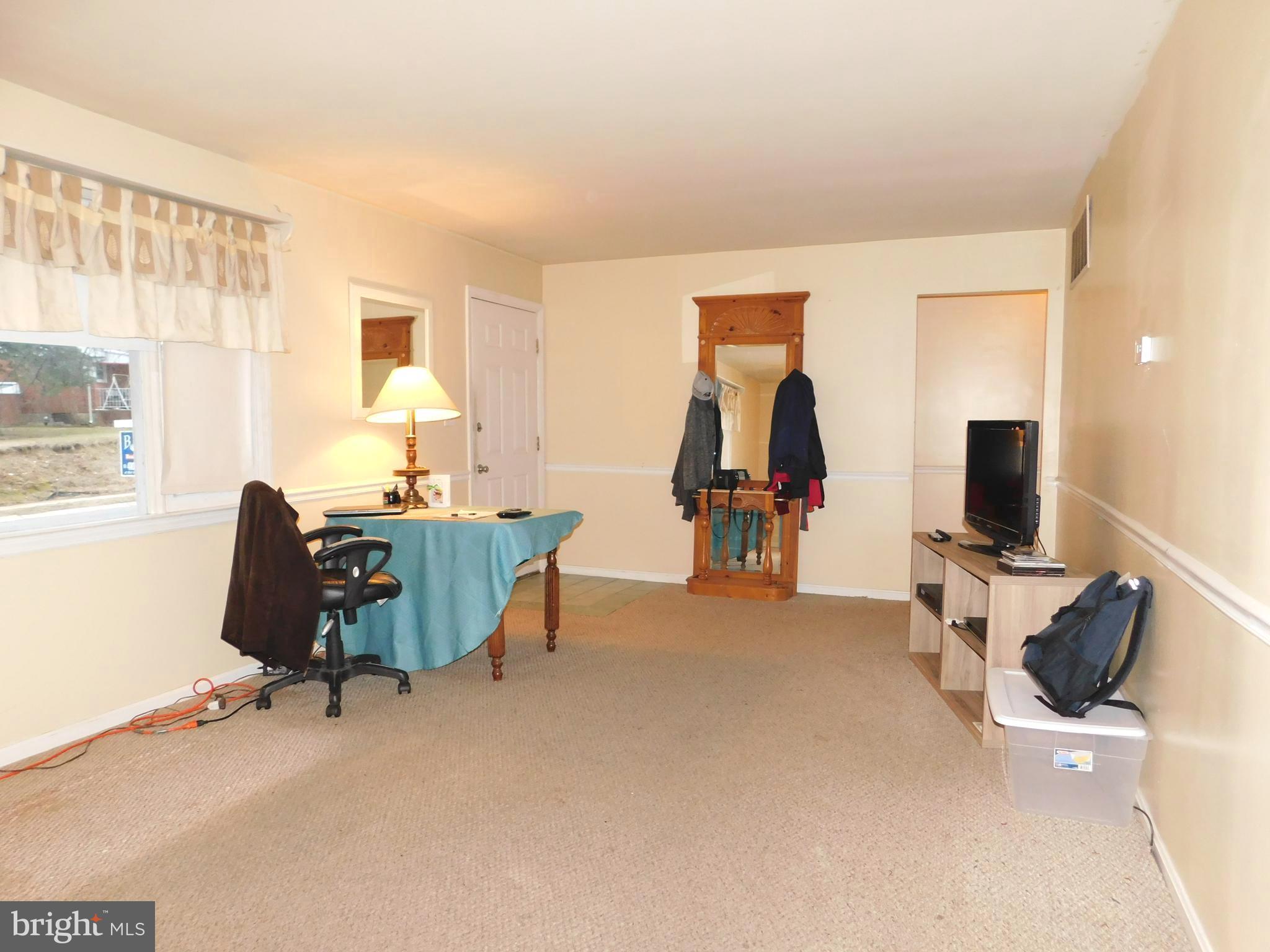 224 Cheddington Road Linthicum, MD 21090 - Photo 3 of 18 a living room with furniture and a flat screen tv