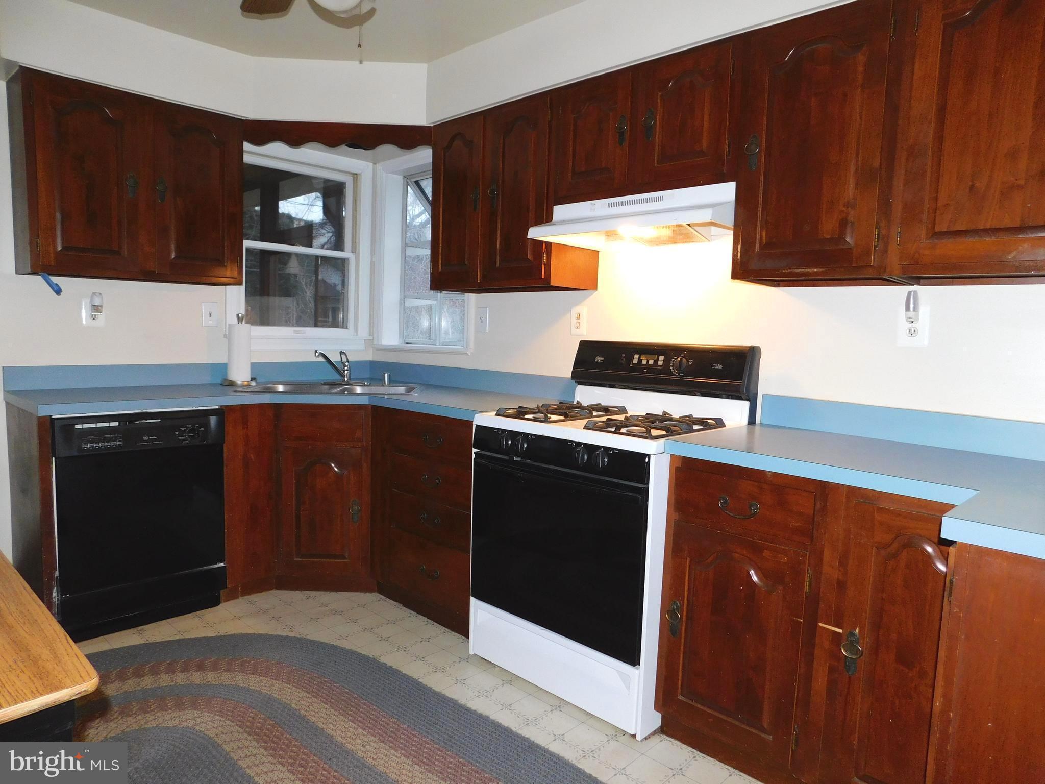 224 Cheddington Road Linthicum, MD 21090 - Photo 9 of 18 a kitchen with stainless steel appliances a stove and a microwave