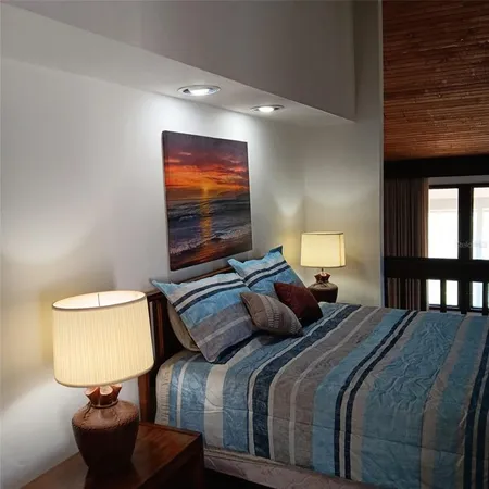 a bedroom with bed and a night stand
