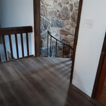 a view of staircase with railing and white walls