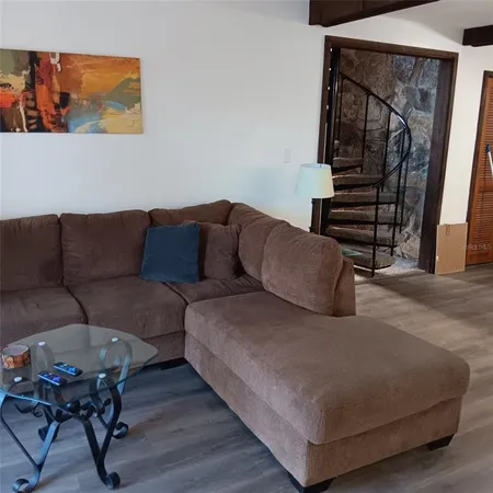 a living room with furniture and a painting
