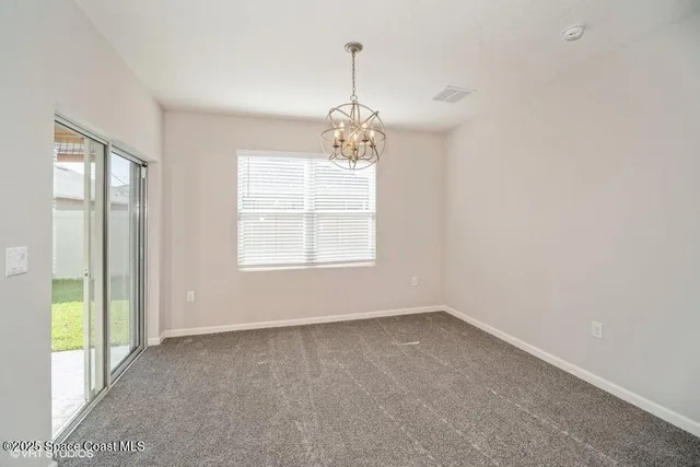 an empty room with windows and entrance