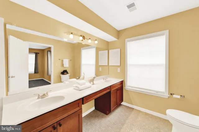 a bathroom with a double vanity sink and a mirror