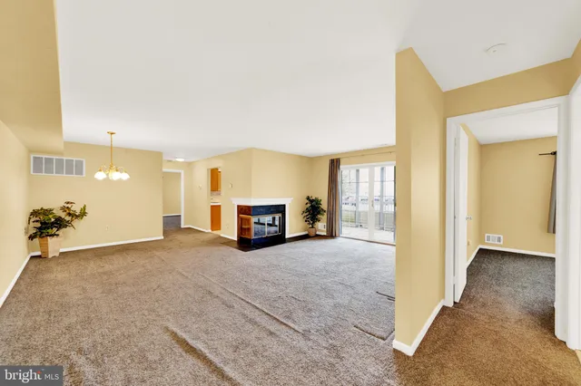 a view of an empty room with a fireplace