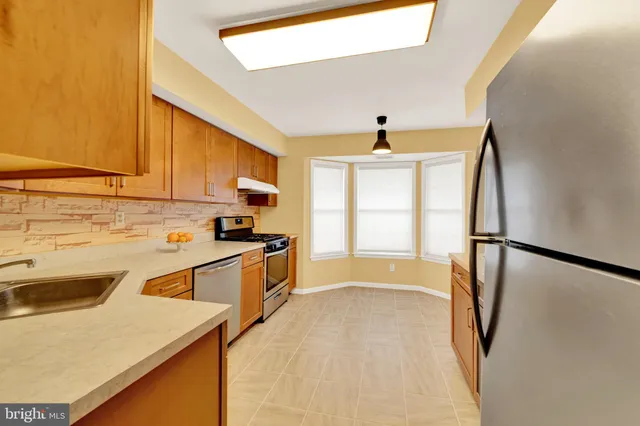 a kitchen with a sink a stove and refrigerator