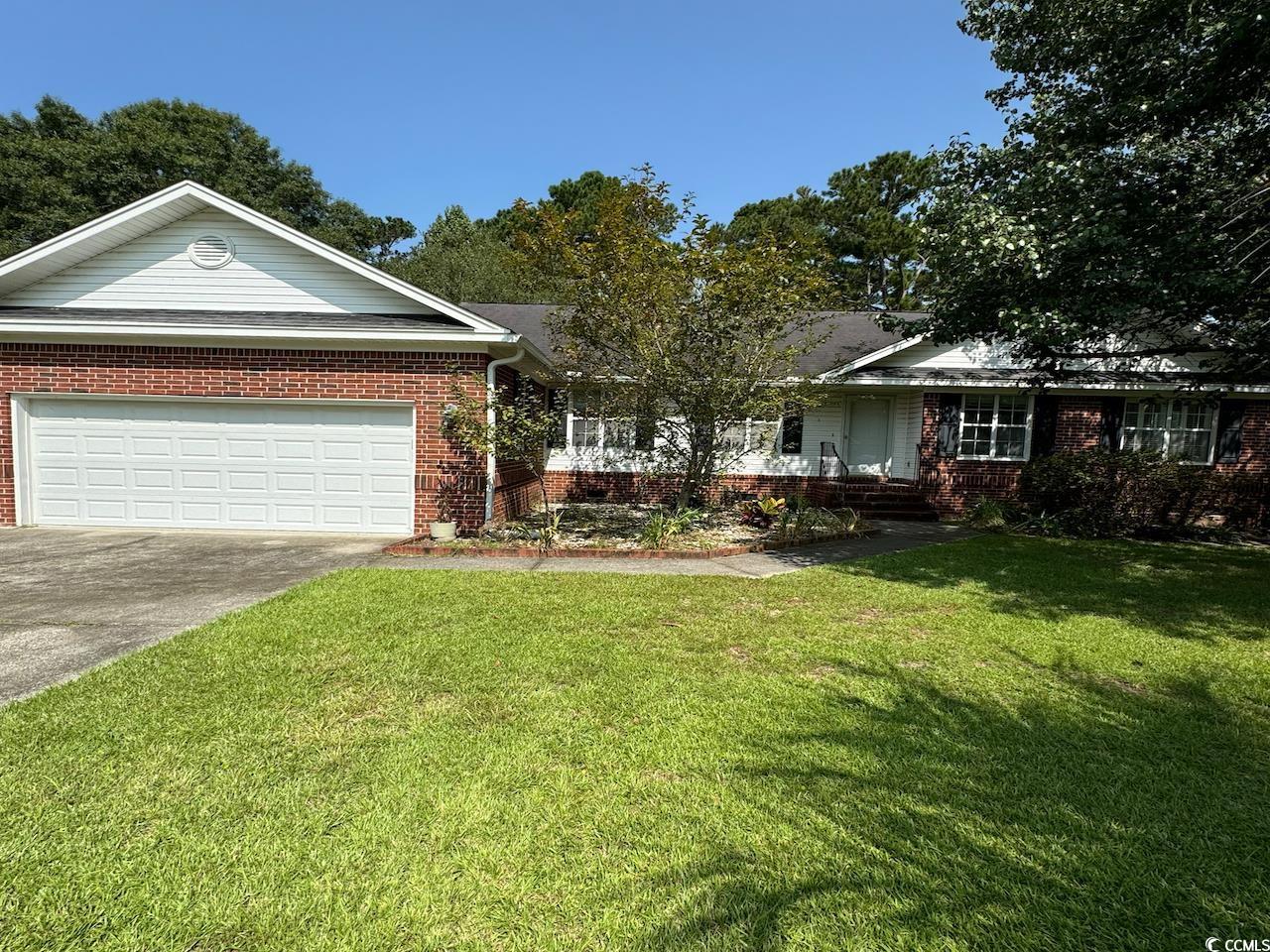 View of front of property with a garage and a fron